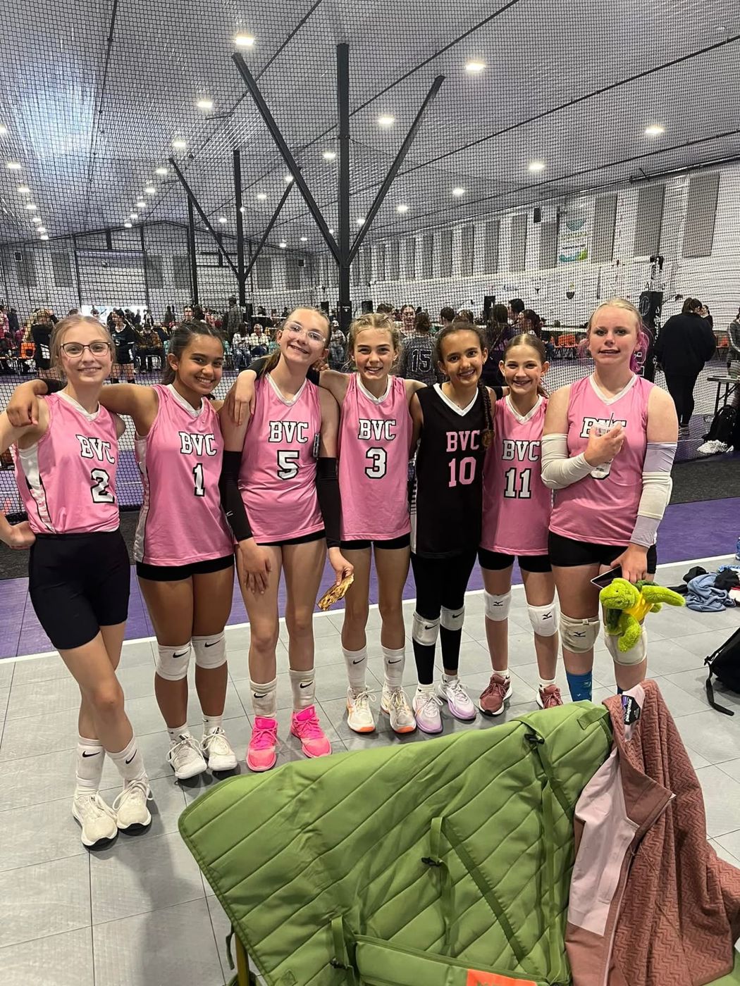 Smiling BVC players in pink jerseys lined up