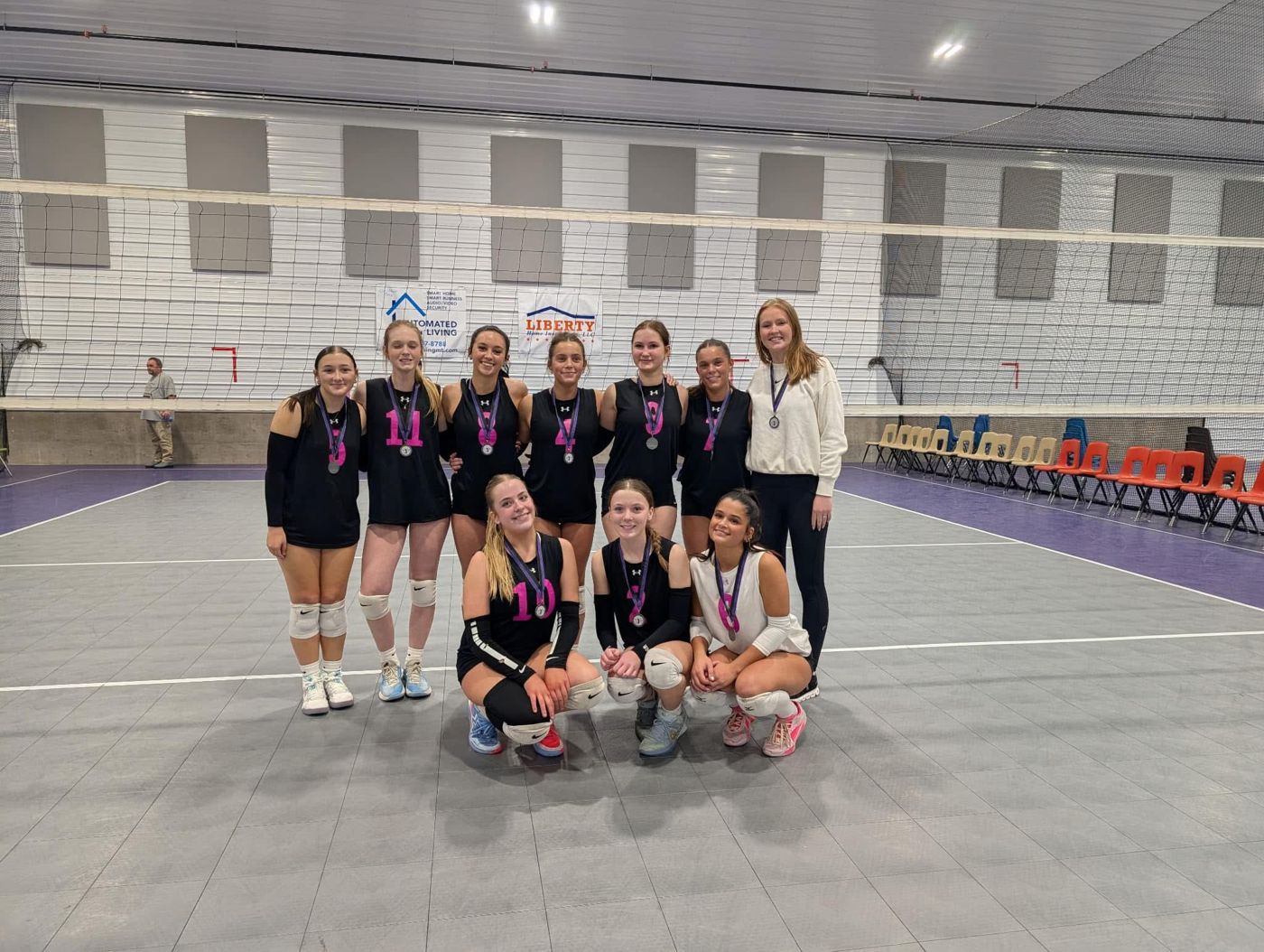 A BVC team in black jerseys with their coach