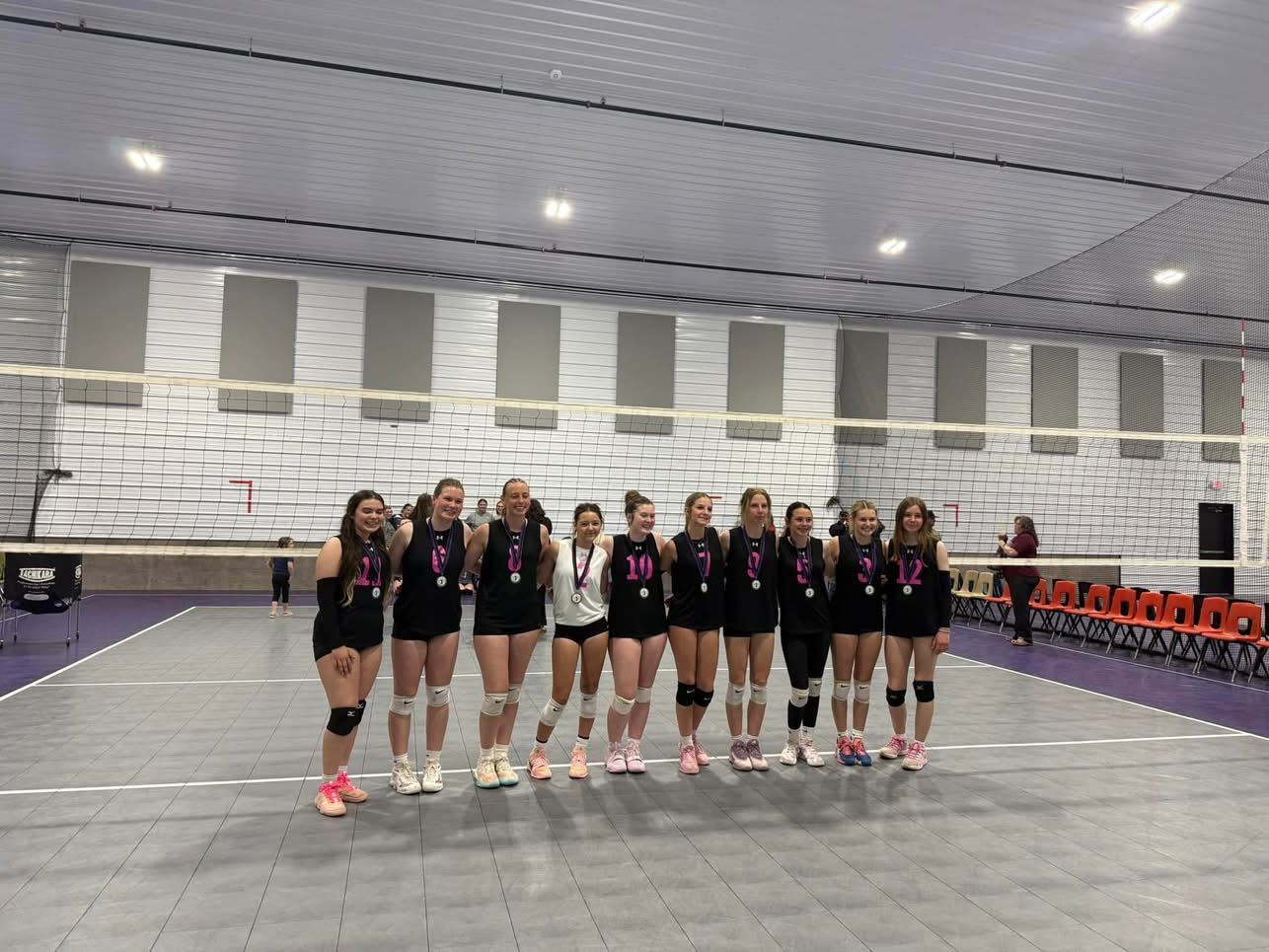 A BVC team in black jerseys lined up on court